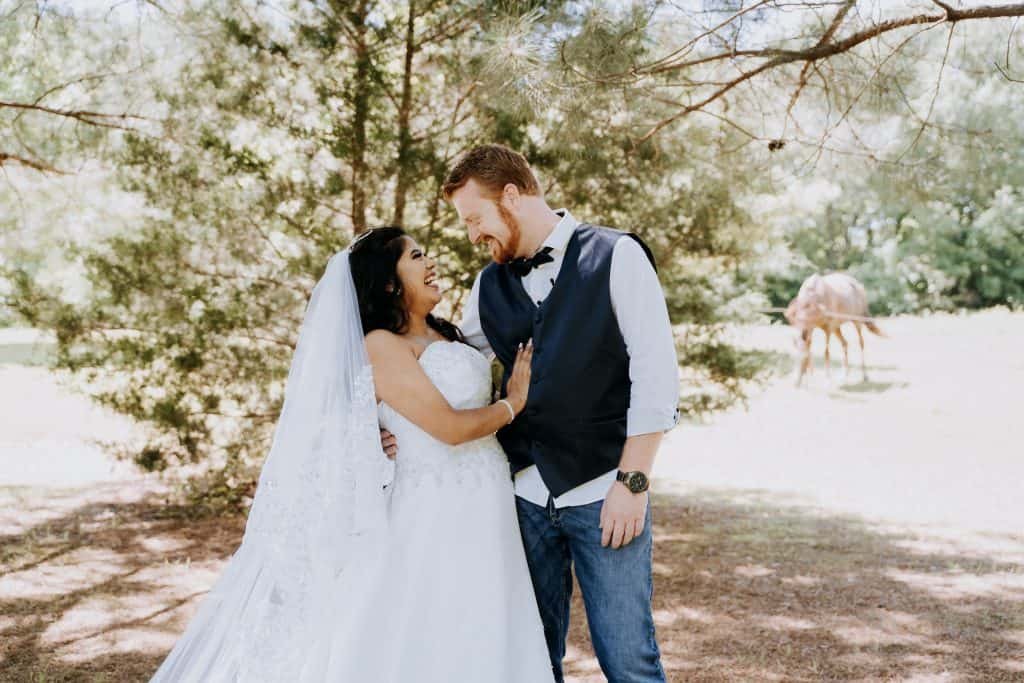 Wedding photo of Bride and Groom laughing looking at each other