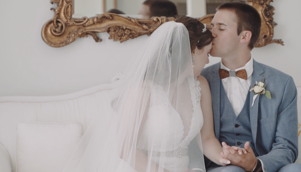 Wedding photo of groom kissing bride on the forehead at the Ravington