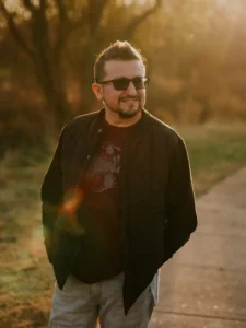 Randy, Haziel team's photographer and videographer, smiling and posing during golden hour.