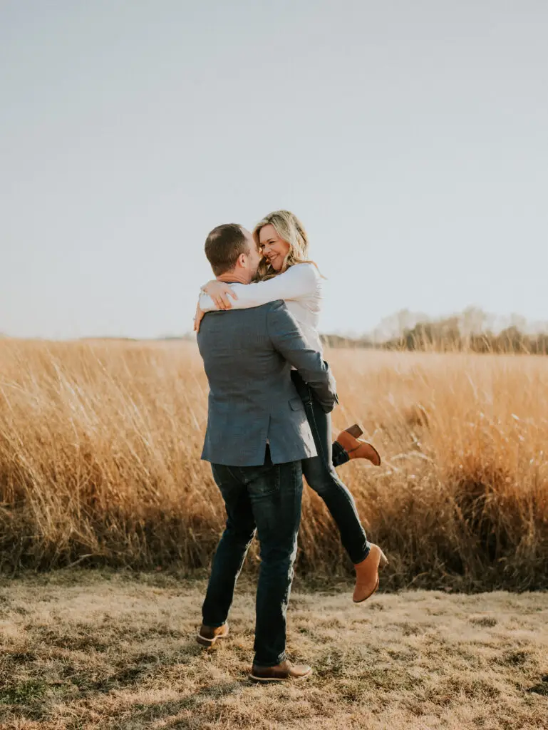 Brian lifting Emberli in a playful moment during their engagement session.