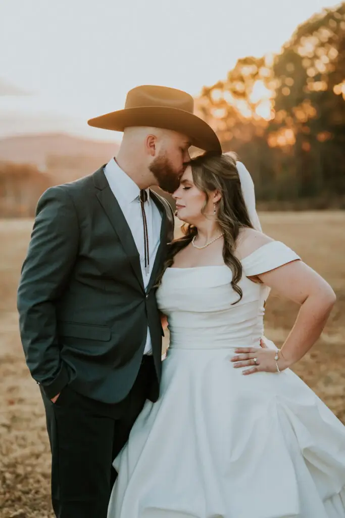 Wedding Content Creation 4 Groom in a grey suit kissing his bride outdoors
