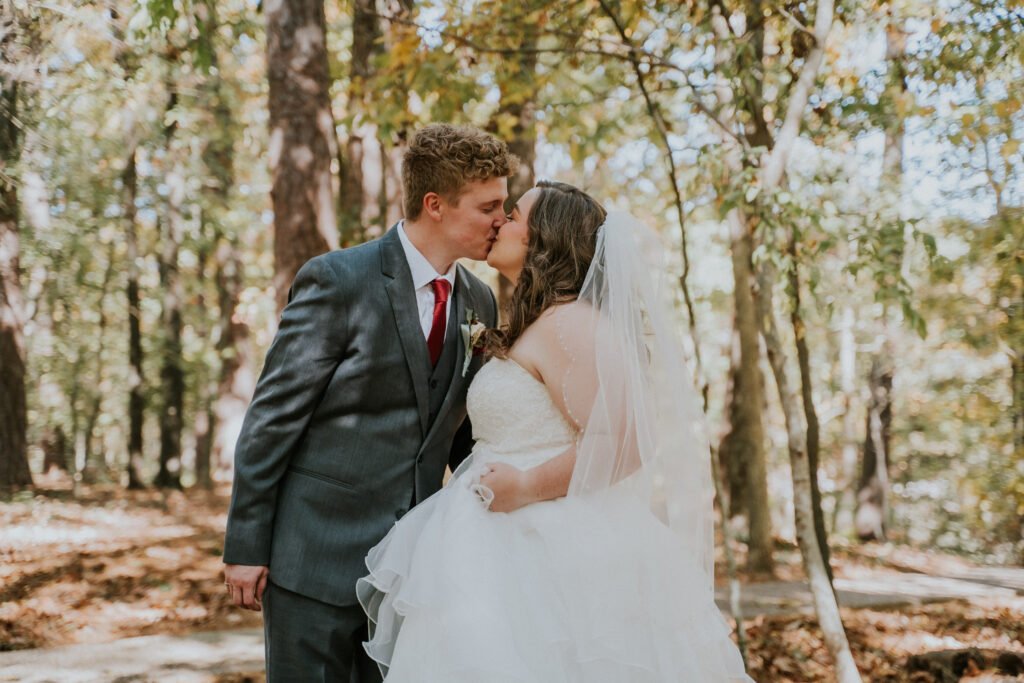 Elopement portraits in the trees outside Mildred B. Cooper Memorial Chapel, Bella Vista, Arkansas