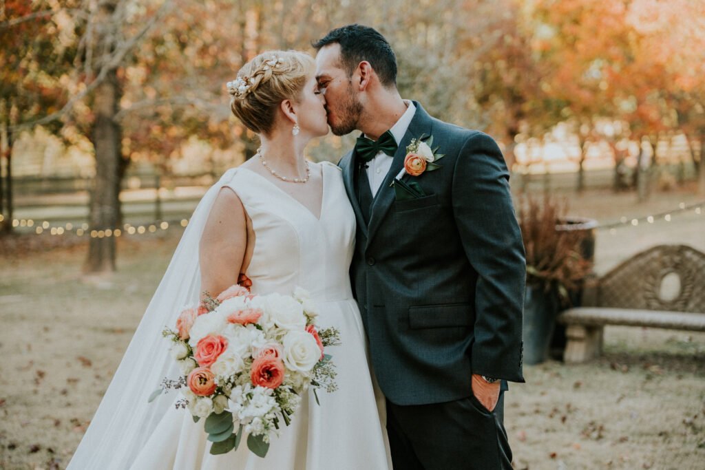 Newlyweds kiss after their ceremony at Stone Chapel at MattLane Farm, Fayetteville, Arkansas