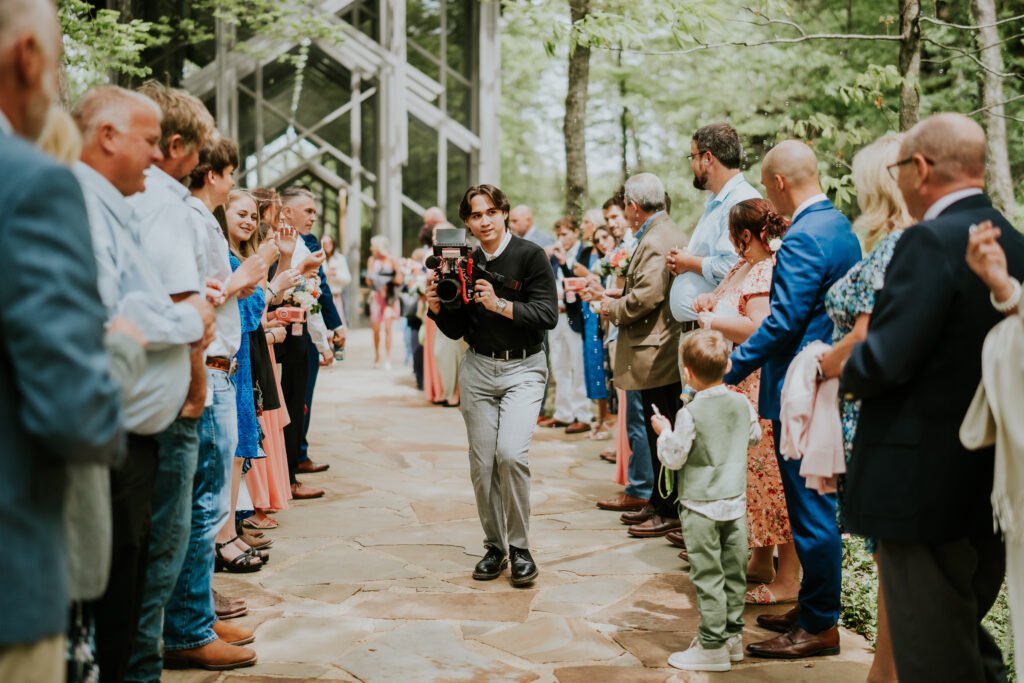Guests line the aisle for a small wedding at Thorncrown Chapel in Eureka Springs, Arkansas