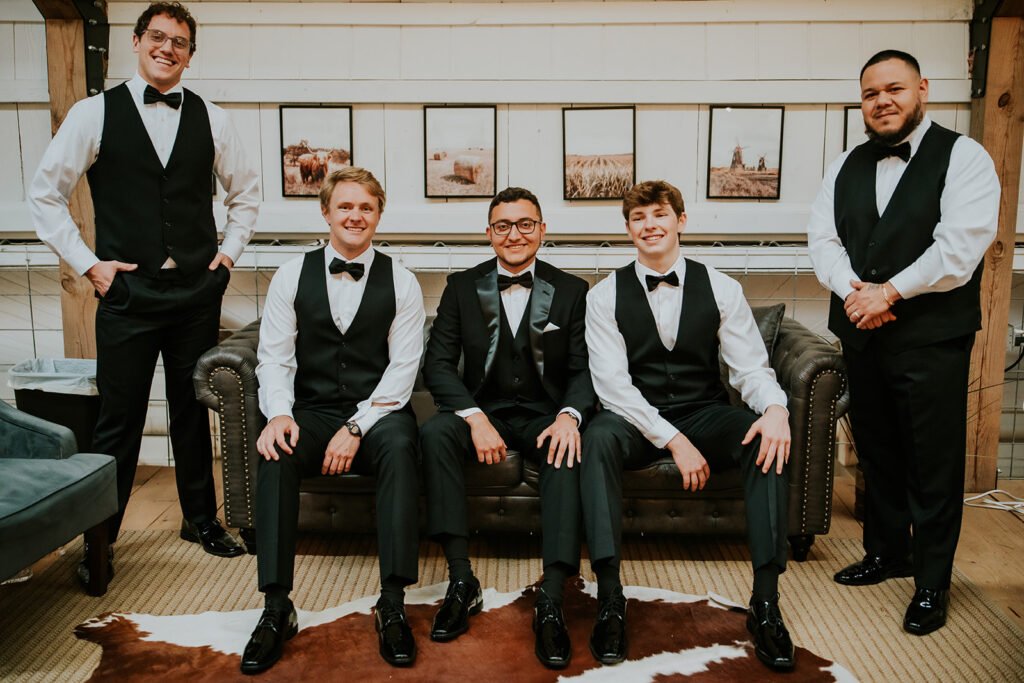 Groom and groomsmen in the upstairs loft getting ready space at Holland Barn in Highfill, Arkansas
