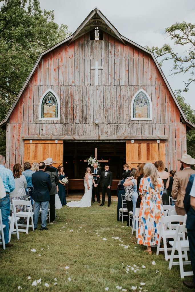 Outdoor wedding ceremony on the lawn in front of Amy's Chapel at Holland Barn