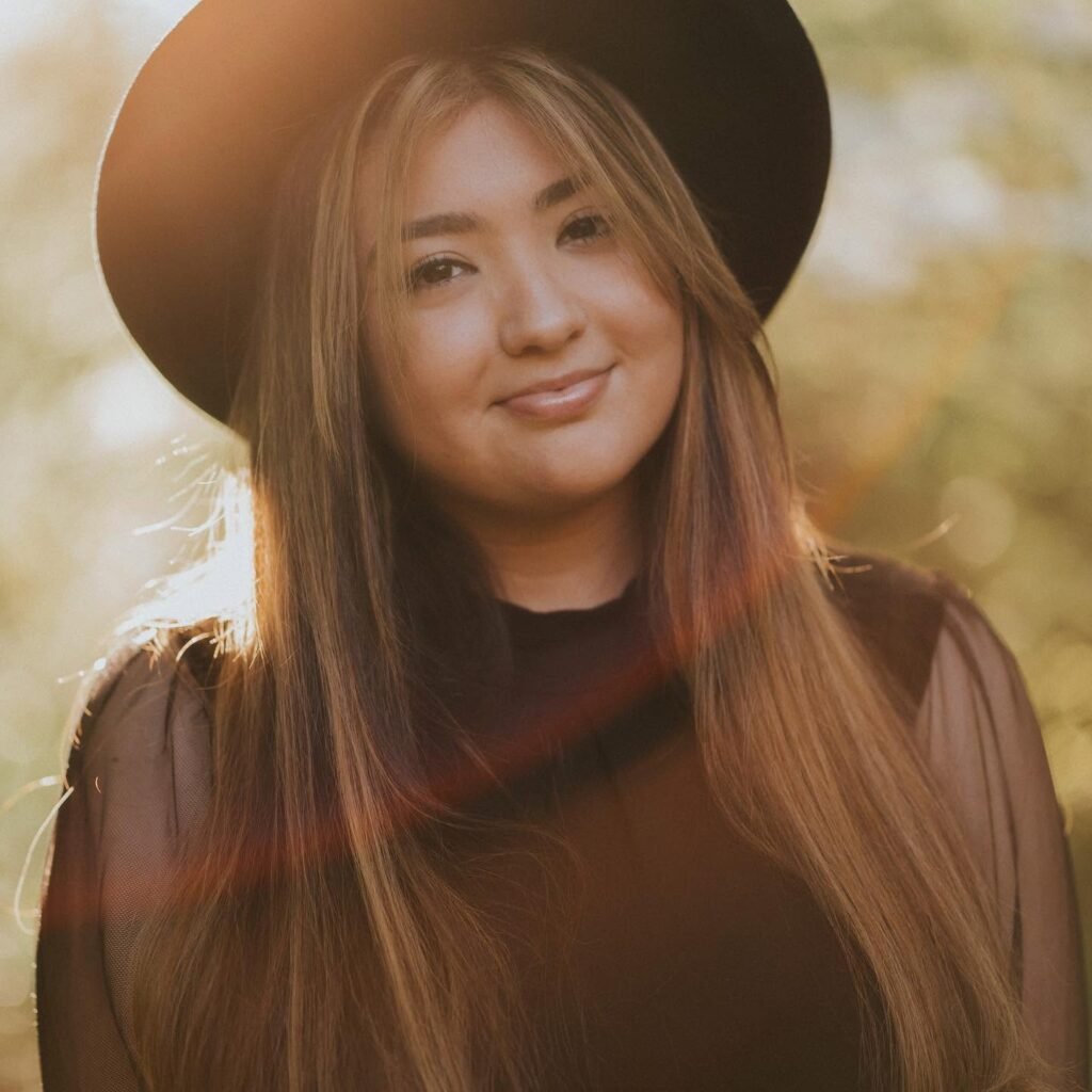 Senior portrait in a wide-brim hat in warm fall light, Northwest Arkansas