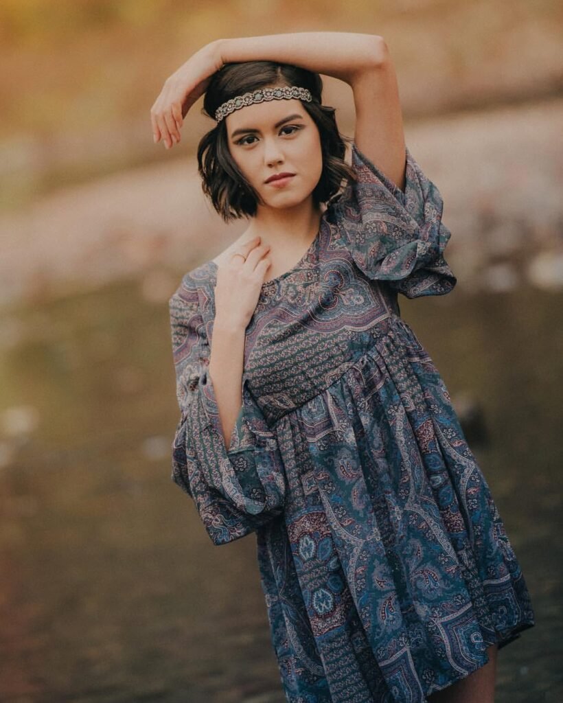 Senior girl in a flowy patterned dress with a headband, soft boho senior portrait NWA