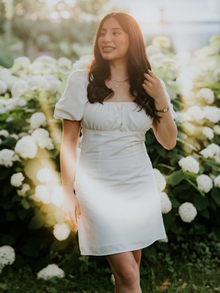 Senior girl in a white dress among blooming hydrangeas, spring senior pictures NWA