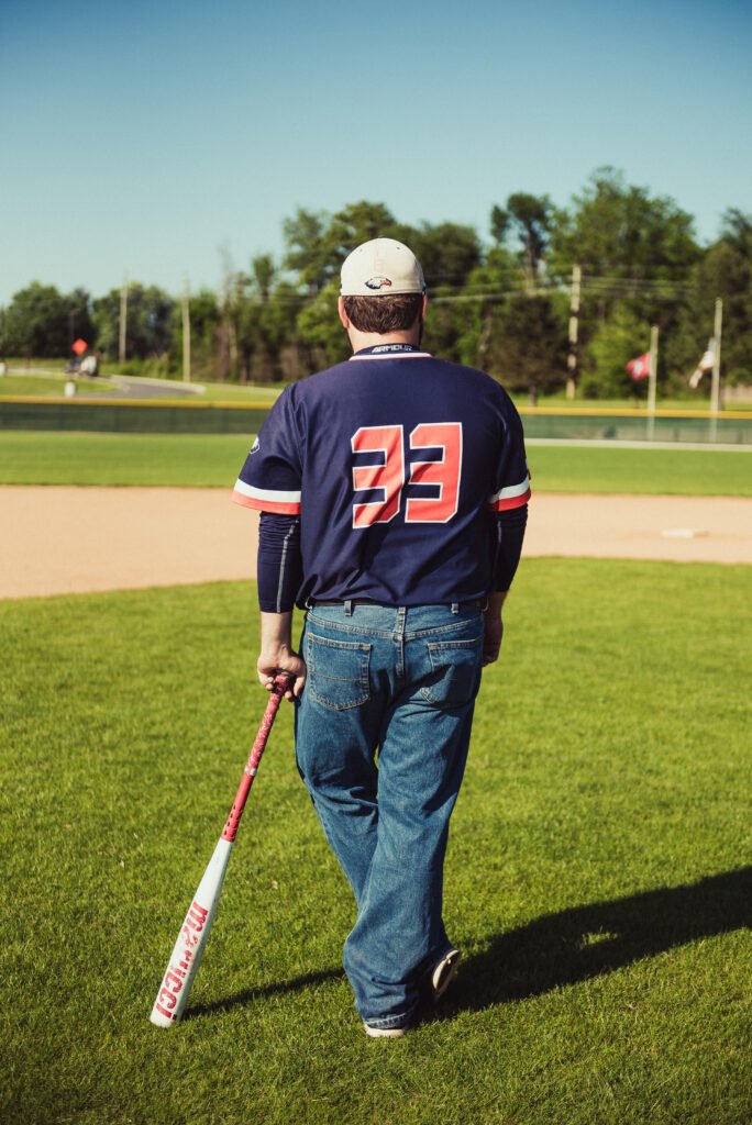 Senior baseball player walking onto the field in his jersey