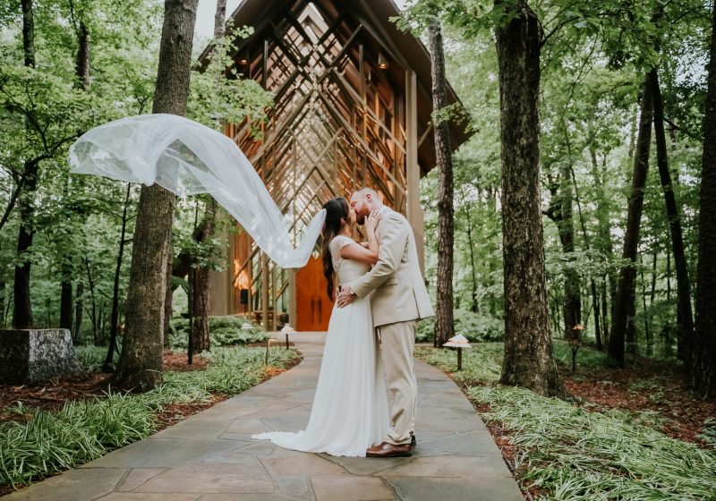 Bride's veil catching the wind outside Thorncrown Chapel in Eureka Springs, Arkansas