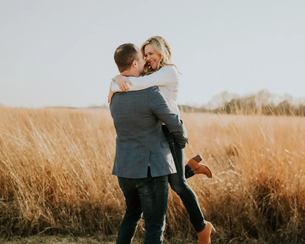 Brian lifting Emberli in a playful moment during their engagement session.