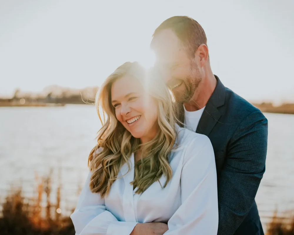 Emberli and Brian laughing together during their Osage Park engagement session.