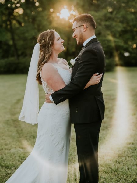 Bride and groom laughing together in golden afternoon light