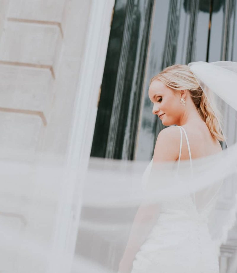 Bridal session photo of bride with long veil at Old Main