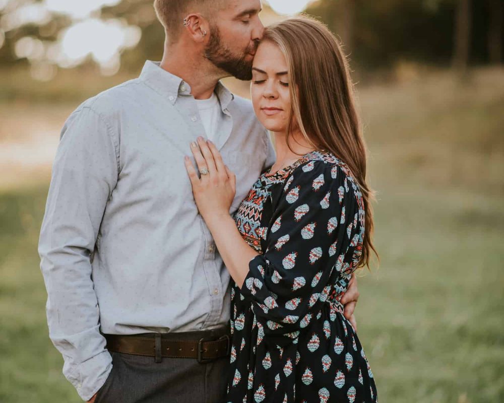 couple-kissing-engagement-session-sunset